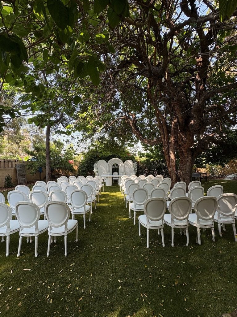 Engagement moment captured in Beit Tout’s serene garden with rustic elegance